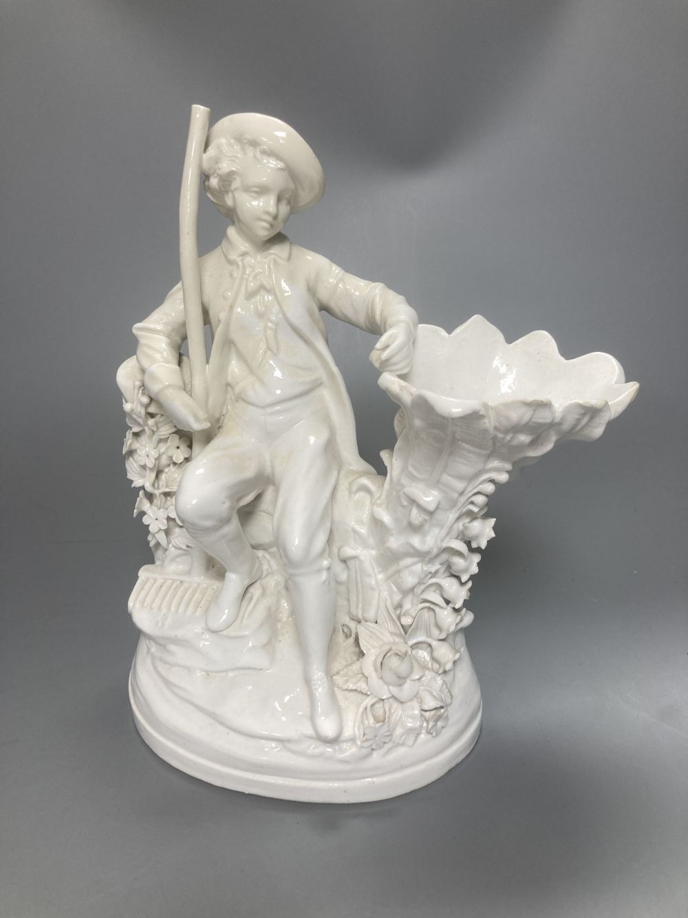 A pair of John Bevington bone china figures, gardener and female companion, 21.5cm